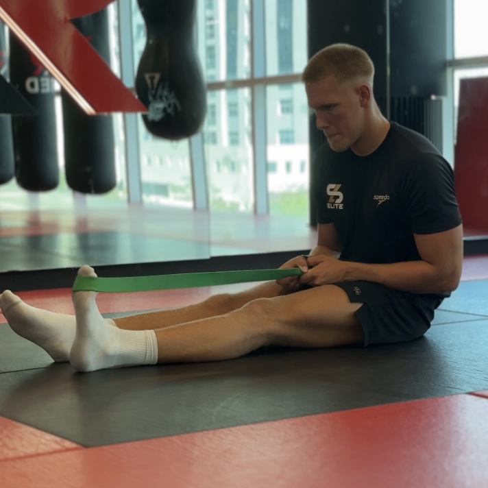 Seated ankle mobility drill with a resistance band